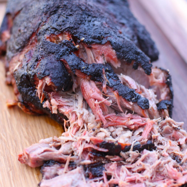Smoked shoulder being pulled apart.