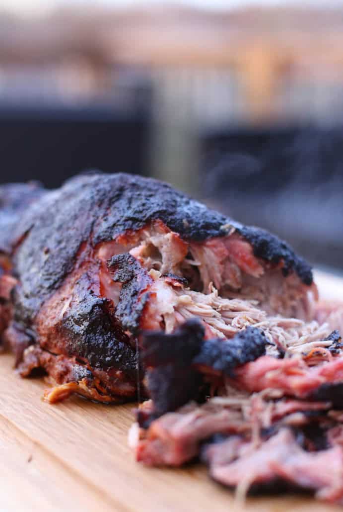 Smoked pork shoulder being shredded