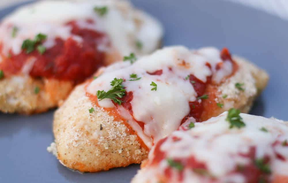 Baked Chicken Parmesan on a grey plate