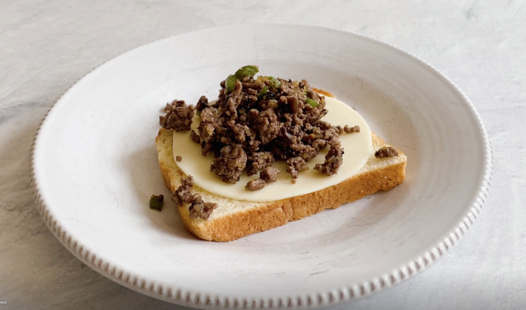 Meat filling for ground beef sandwiches on top of cheese and bread
