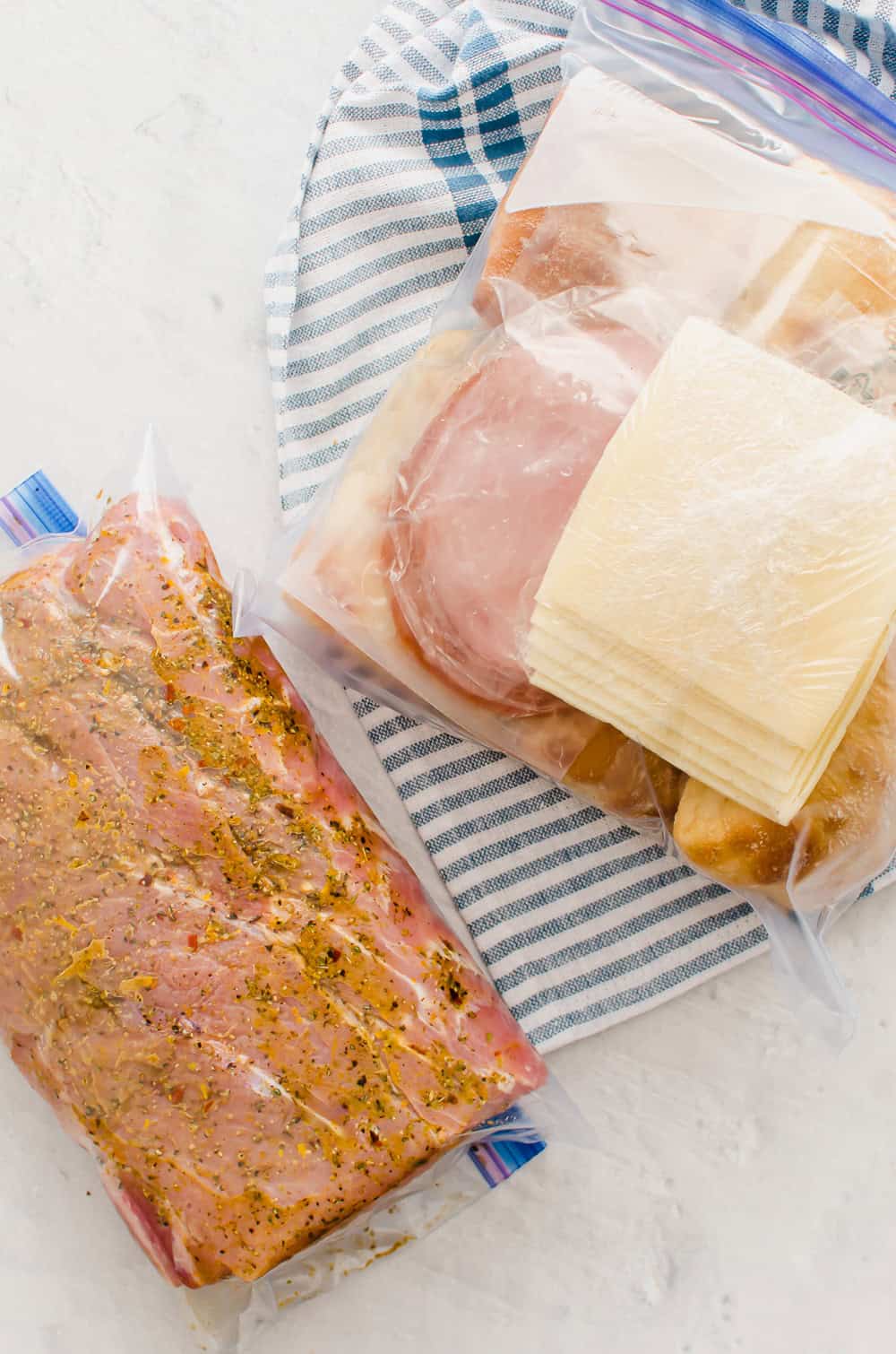 Ingredients for Cuban Pulled Pork Sandwiches in freezer bags to make a freezer meal kit.