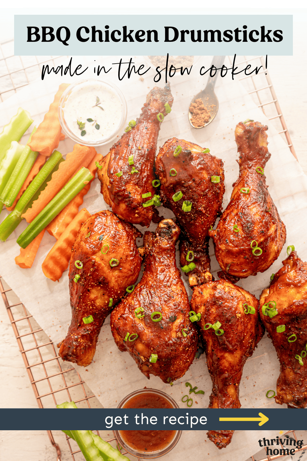 BBQ chicken drumsticks on a baking rack with celery and carrot sticks on the side.