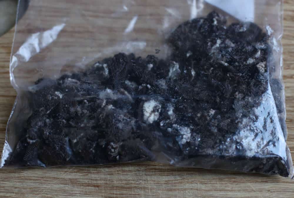 Crushed up Oreos in a baggie.