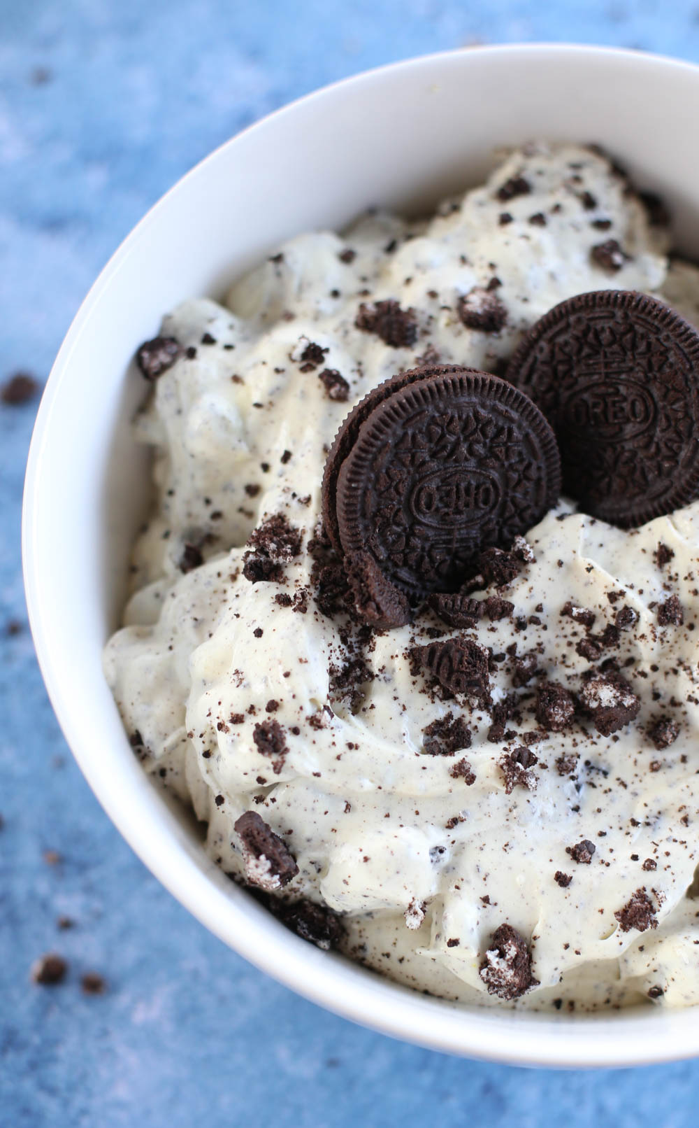 Oreo Fluff in a white bowl with two whole Oreos on top.