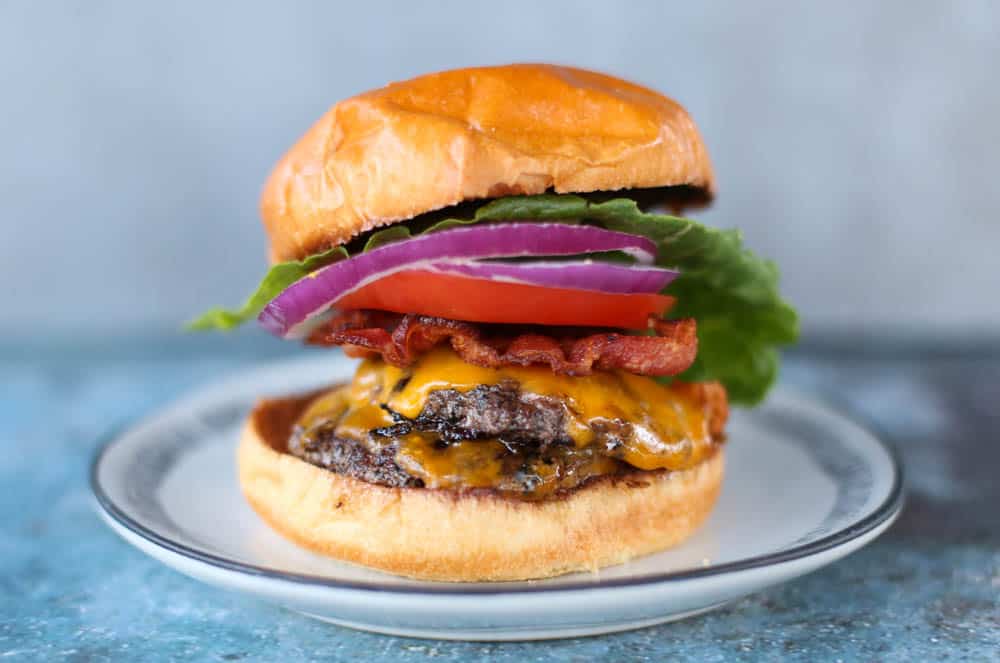 Smash burger on a plate with toppings 