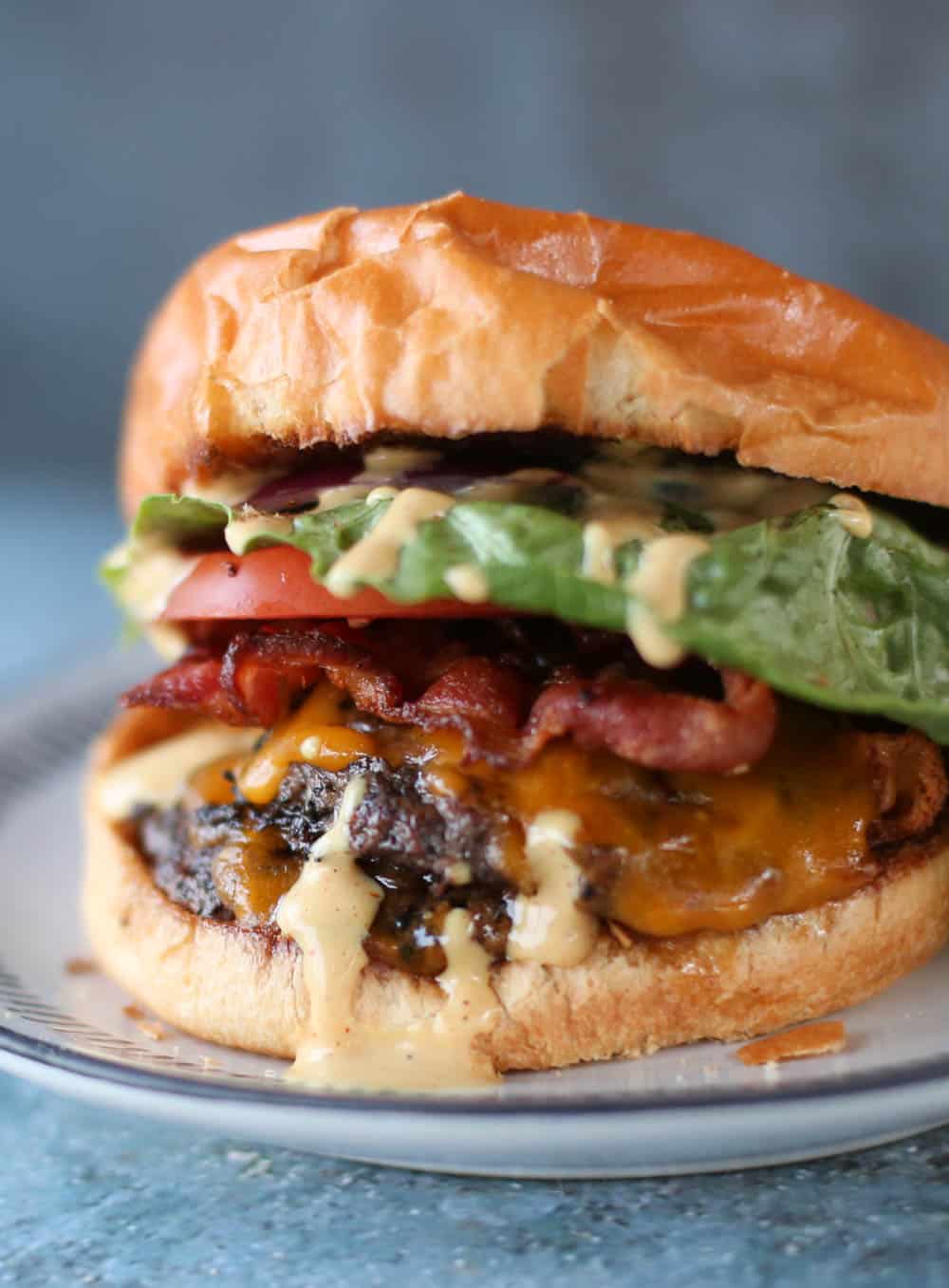 Smash burger with toppings and a secret sauce on a brioche bun.