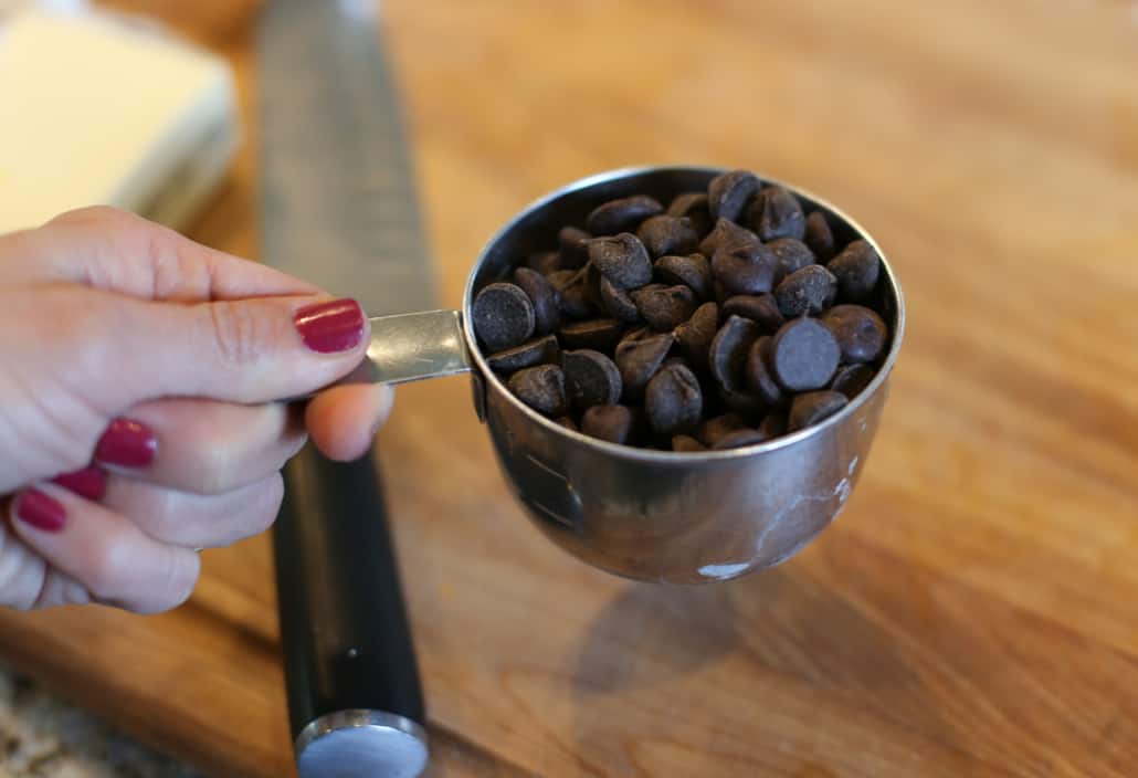 Dark chocolate chips in a measuring cup.