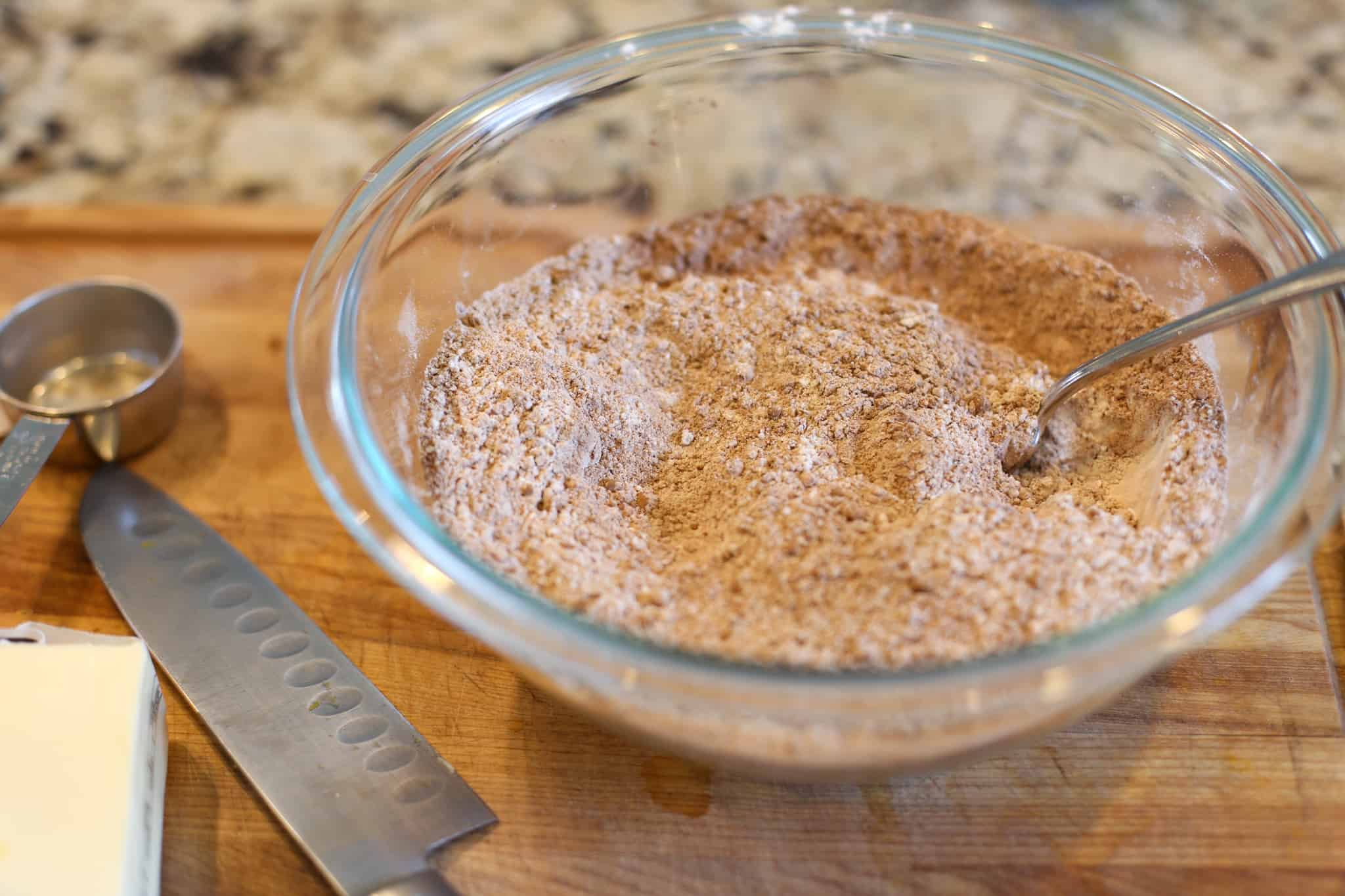 Dry ingredients for dark chocolate coffee cookies mixed together in glass bowl.