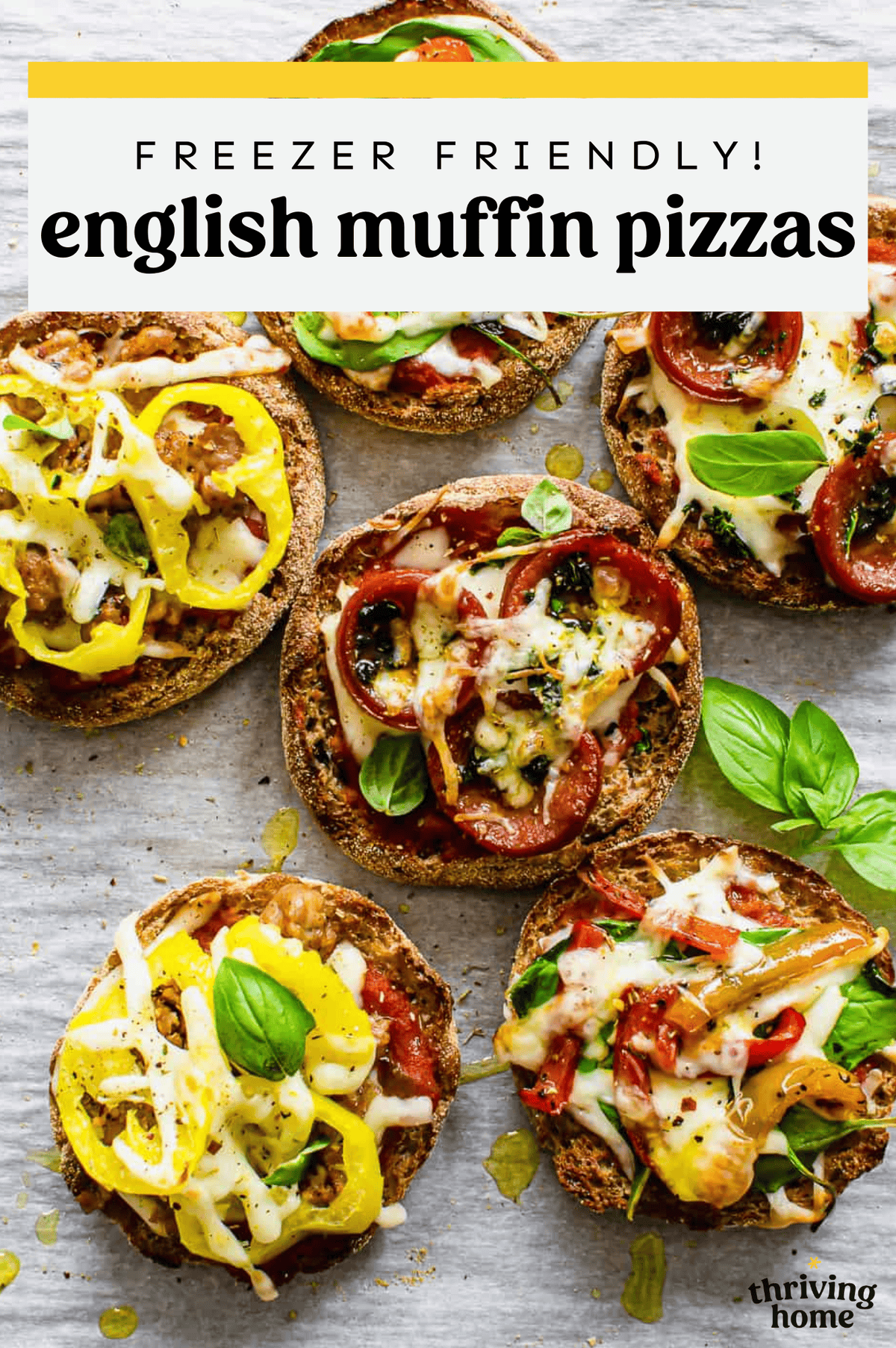 English muffin pizzas straight from the oven on a parchment-lined baking sheet.