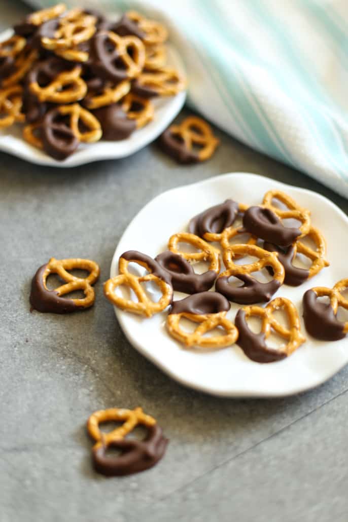 Peanut butter dark chocolate covered pretzels on a white plate