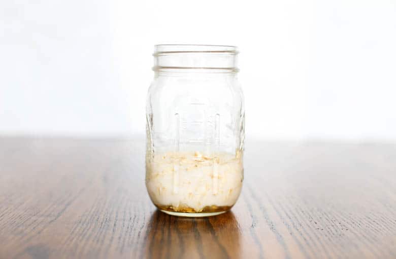 Building the base of overnight oats in a mason jar. 