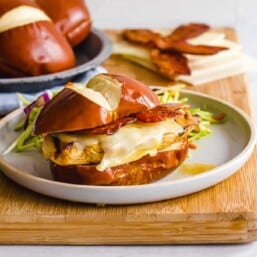 Honey dijon chicken sandwiches on a cutting board.
