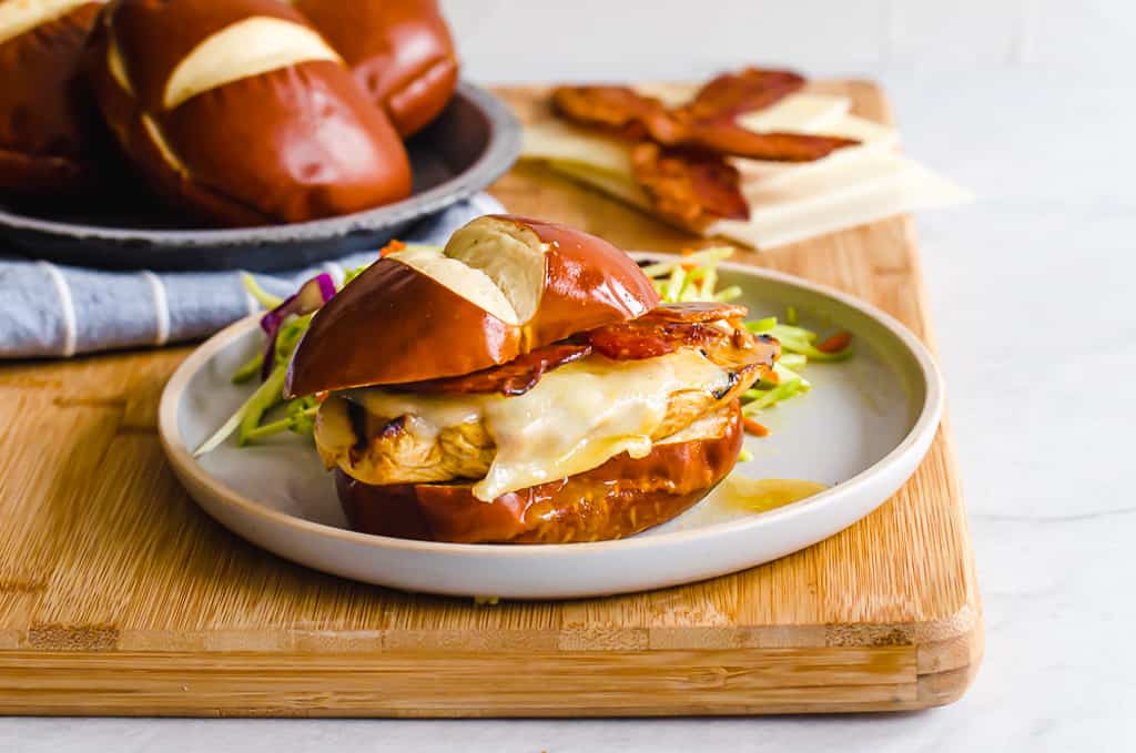 honey dijon chicken sandwich on a white plate with slaw