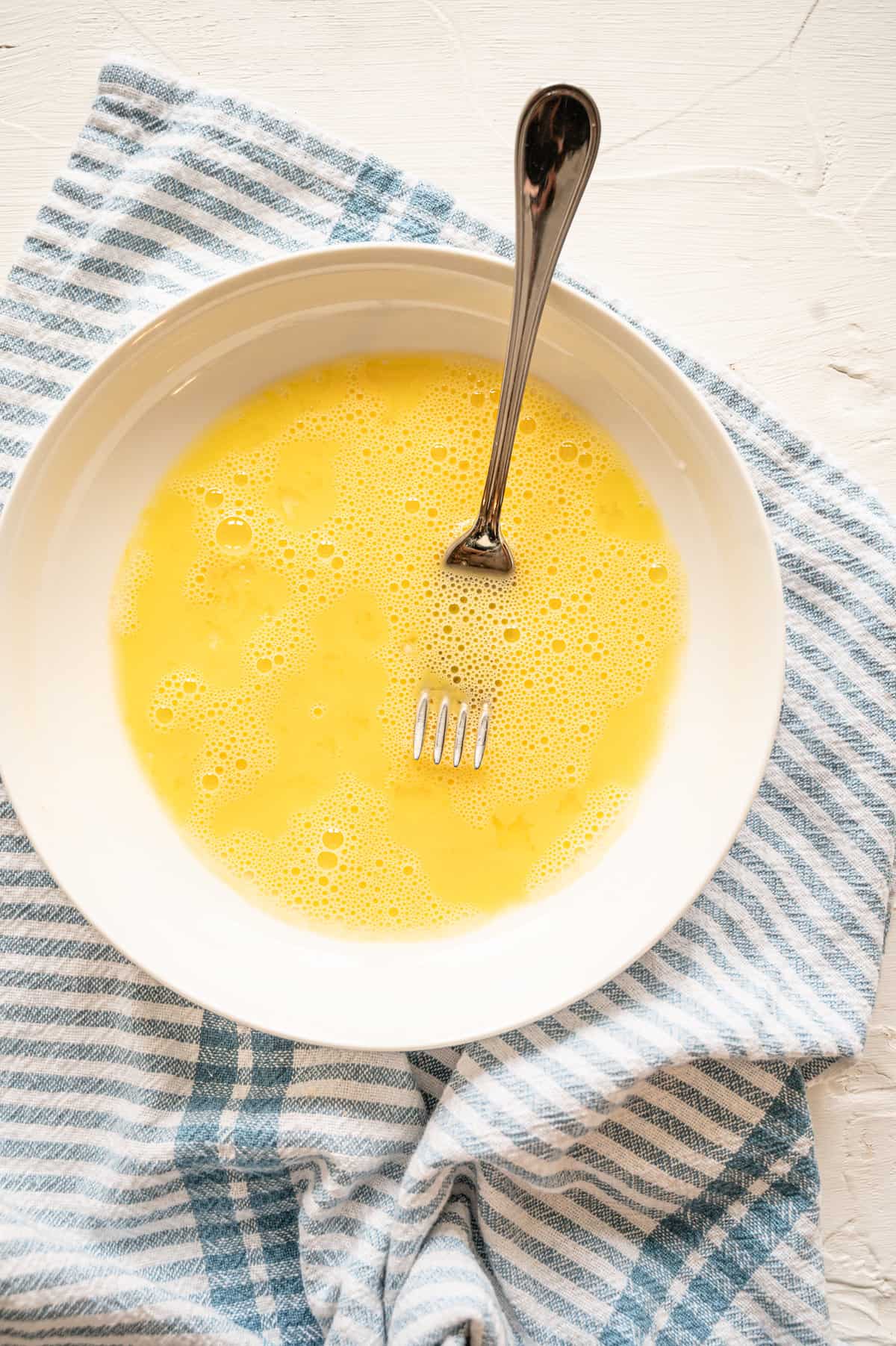 Whisked eggs in a bowl.