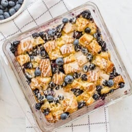 Blueberry French Toast Casserole {with Vanilla Glaze} in a glass casserole dish.