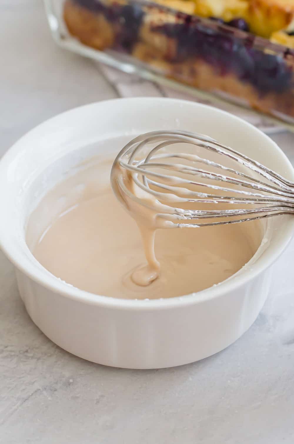 vanilla glaze being whisked in a white bowl