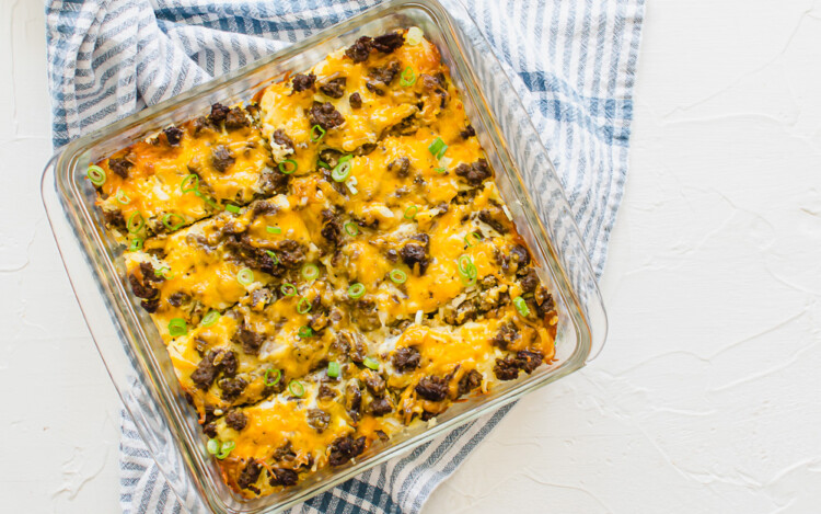 Cheesy breakfast casserole with sausage in a glass pan.