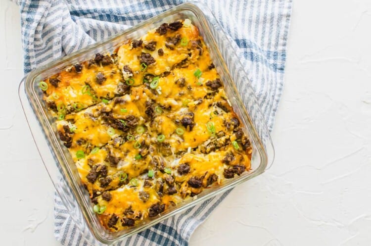 Cheesy breakfast casserole with sausage in a glass pan.