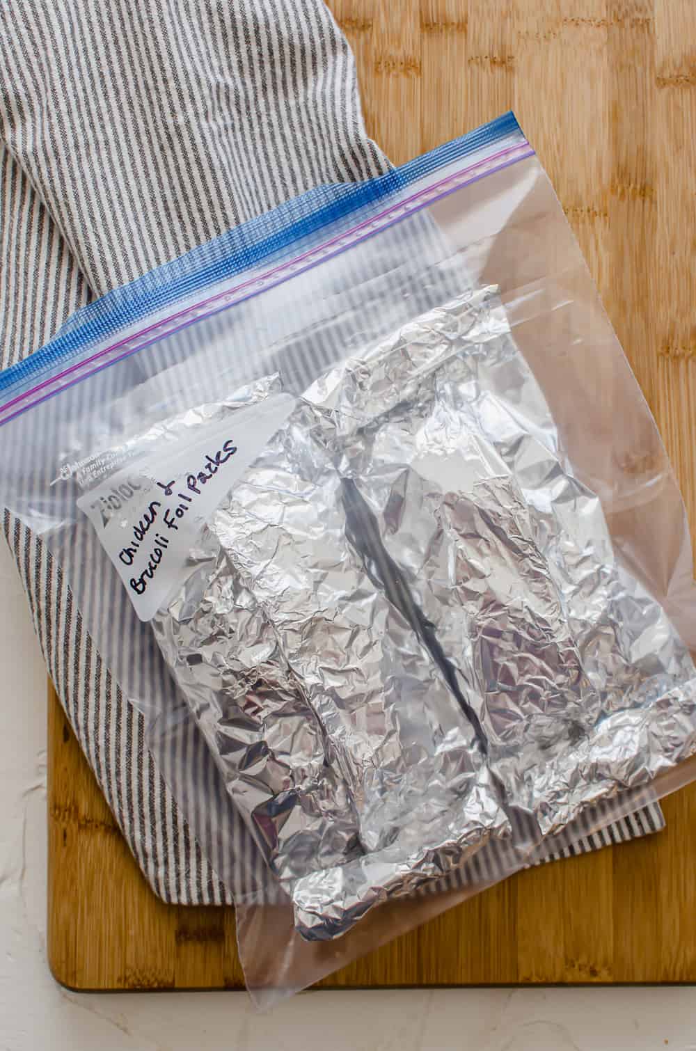 Chicken, broccoli foil packets in a freezer bag.