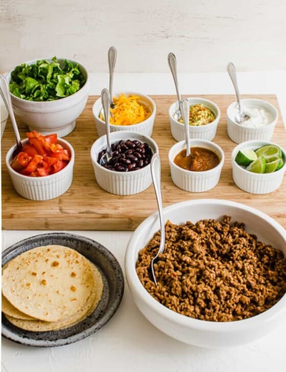 Taco bar with all the toppings lined up ready to serve.