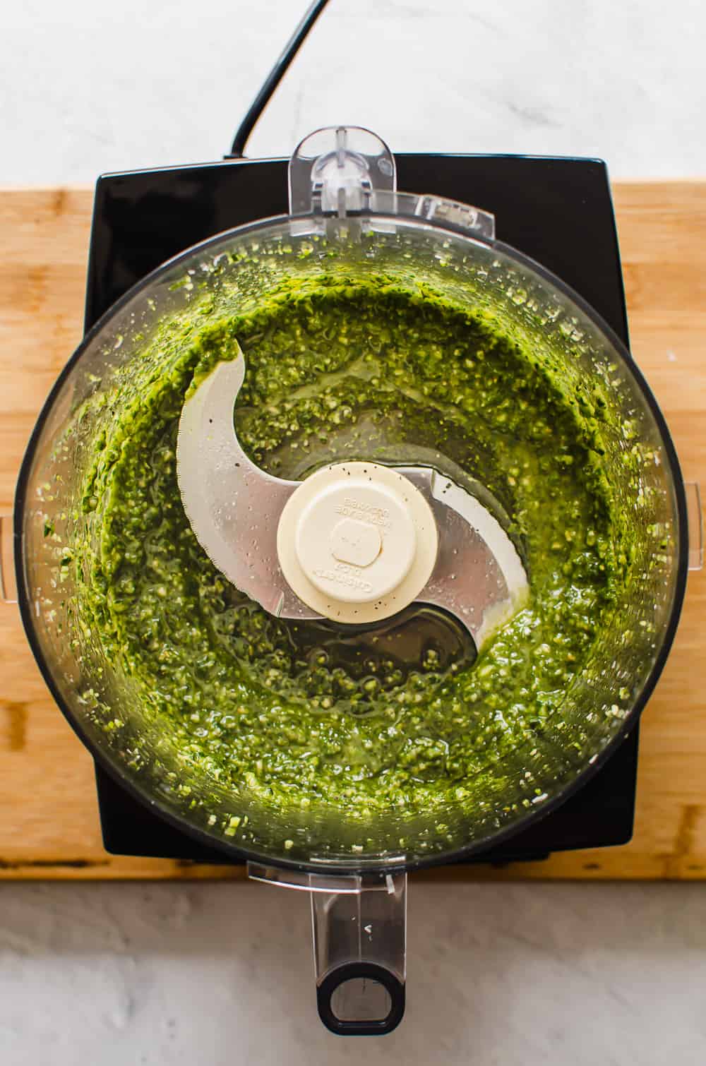 Pesto in a food processor bowl.