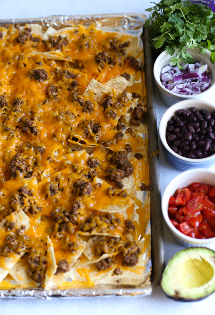 Ground Beef Baked Nachos with toppings in bowls