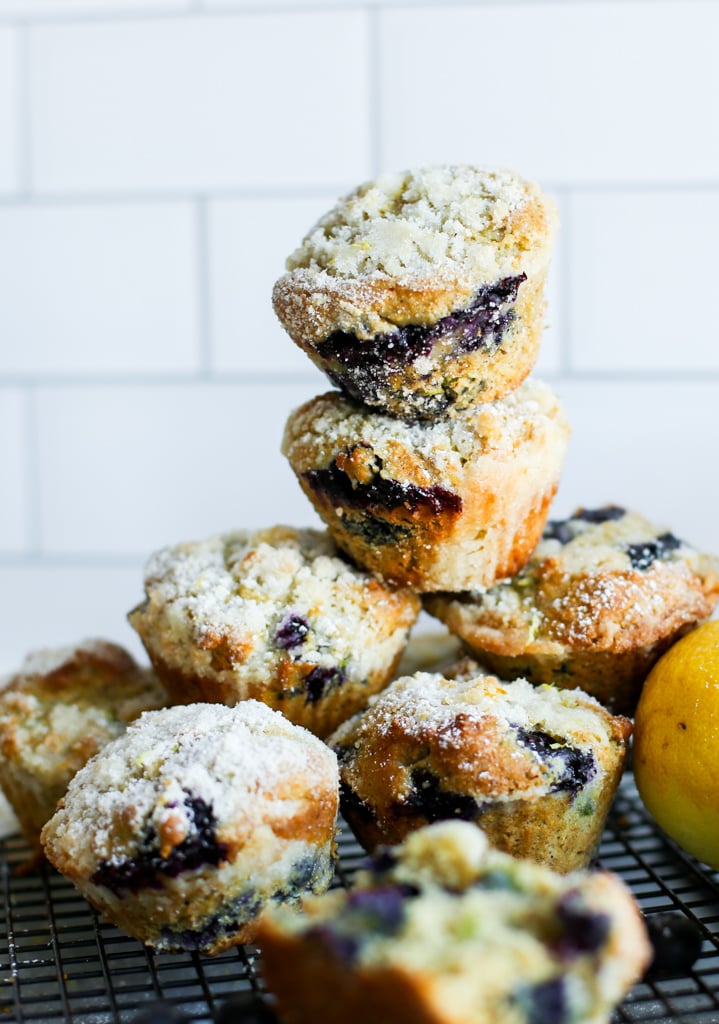 avocado blueberry muffins stacked up on a cooling rack