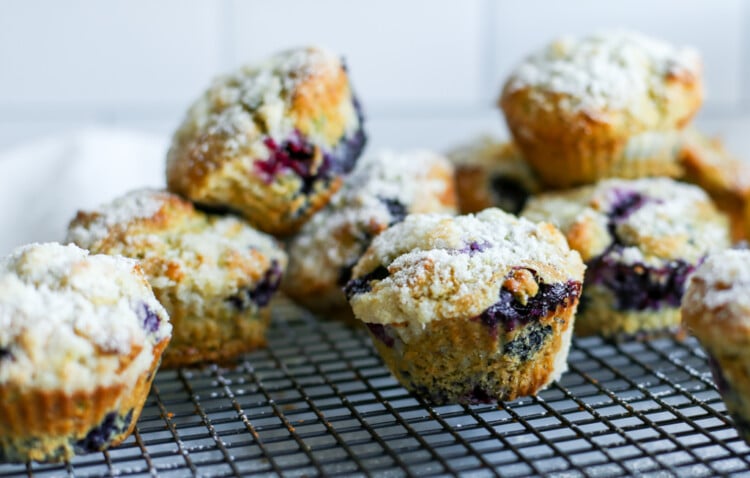Blueberry avocado muffins on a cooling rack.