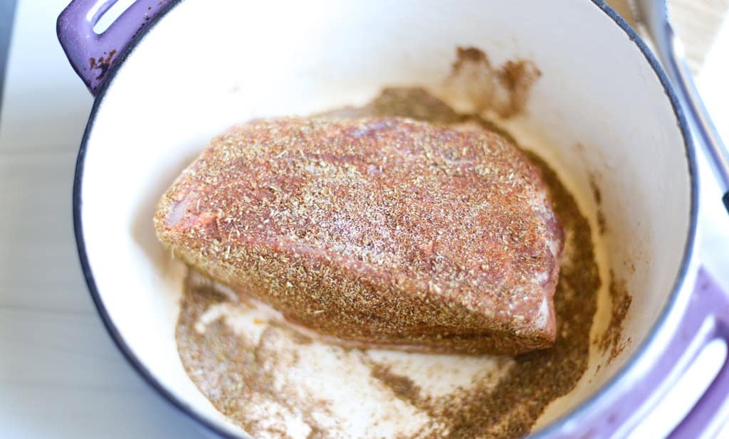 Seasoned pork shoulder in a Dutch Oven.