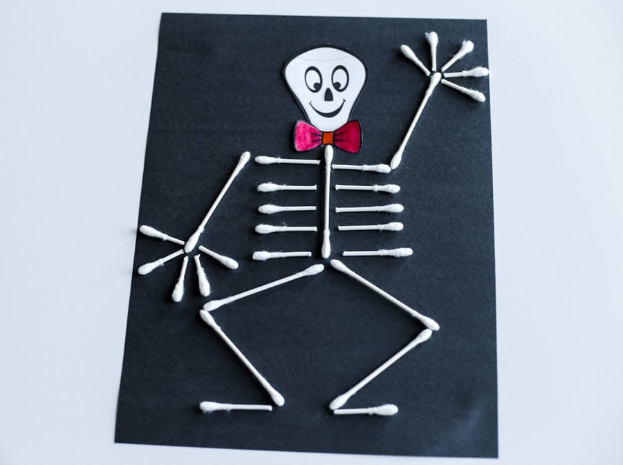 Completed Q-tip skeleton craft with the skeleton waving.