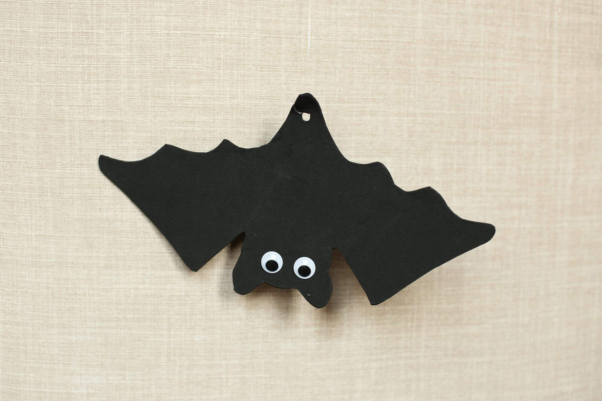 Foam bat craft hanging upside down with fishing line.