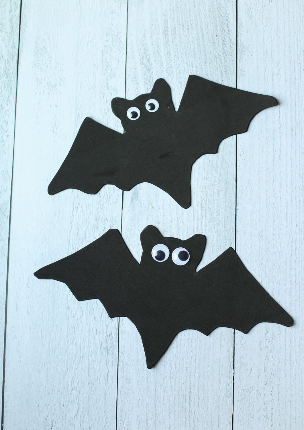 Black foam bats with googly eyes lined up.
