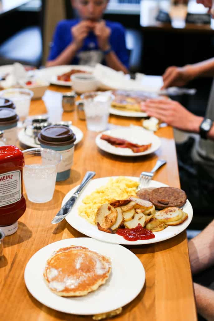 A table with breakfast plates and coffee