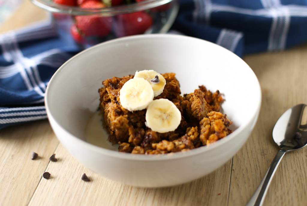 Pumpkin Baked Oatmeal served in a white bowl with banana slices on top.
