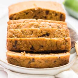 Chocolate chip zucchini bread sliced on a platter.
