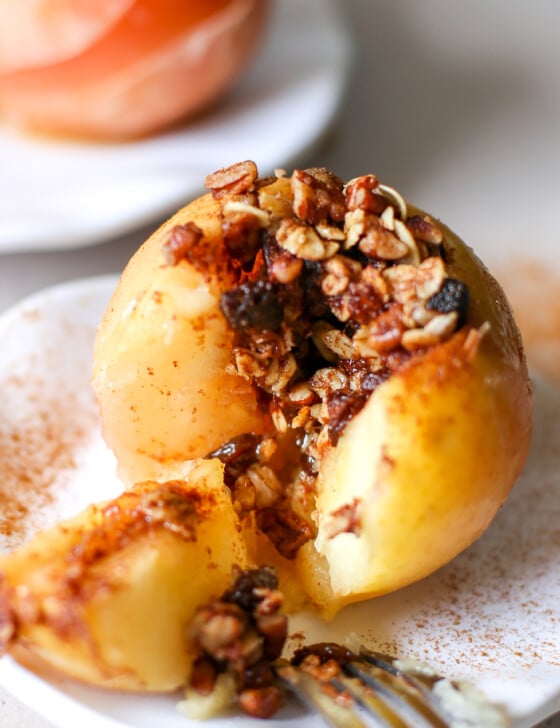 A baked apple split open with the filling spilling out.