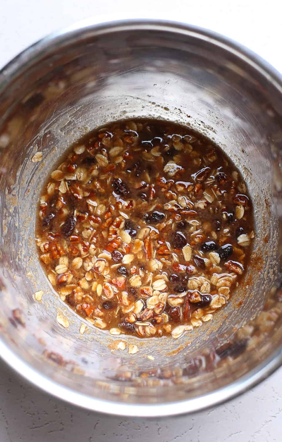 Filling for the baked apples all mixed up in a stainless steel mixing bowl.