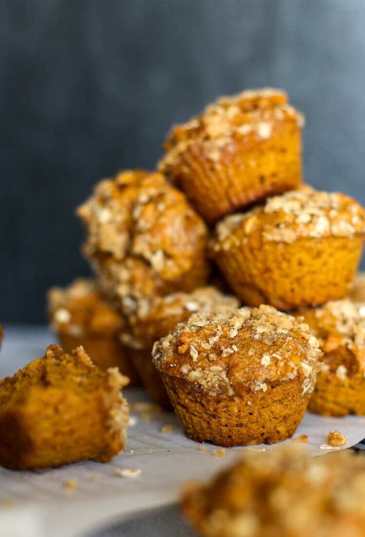 Pumpkin spice muffins stacked on a colling rack.
