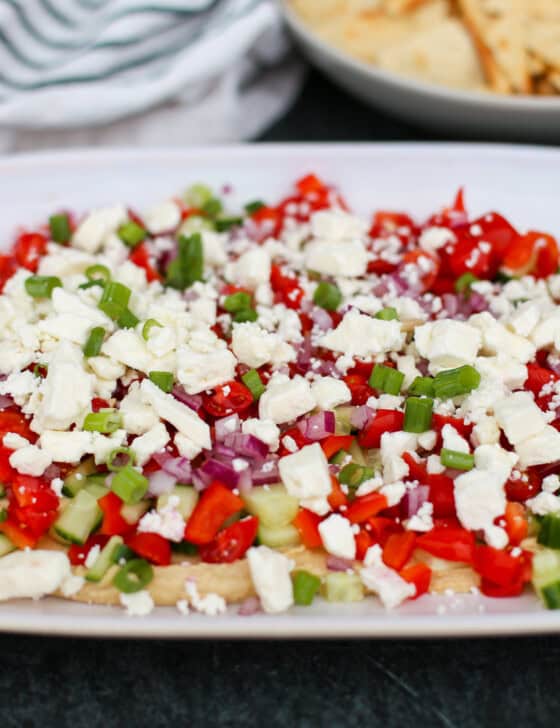 Greek Dip layered on a platter.