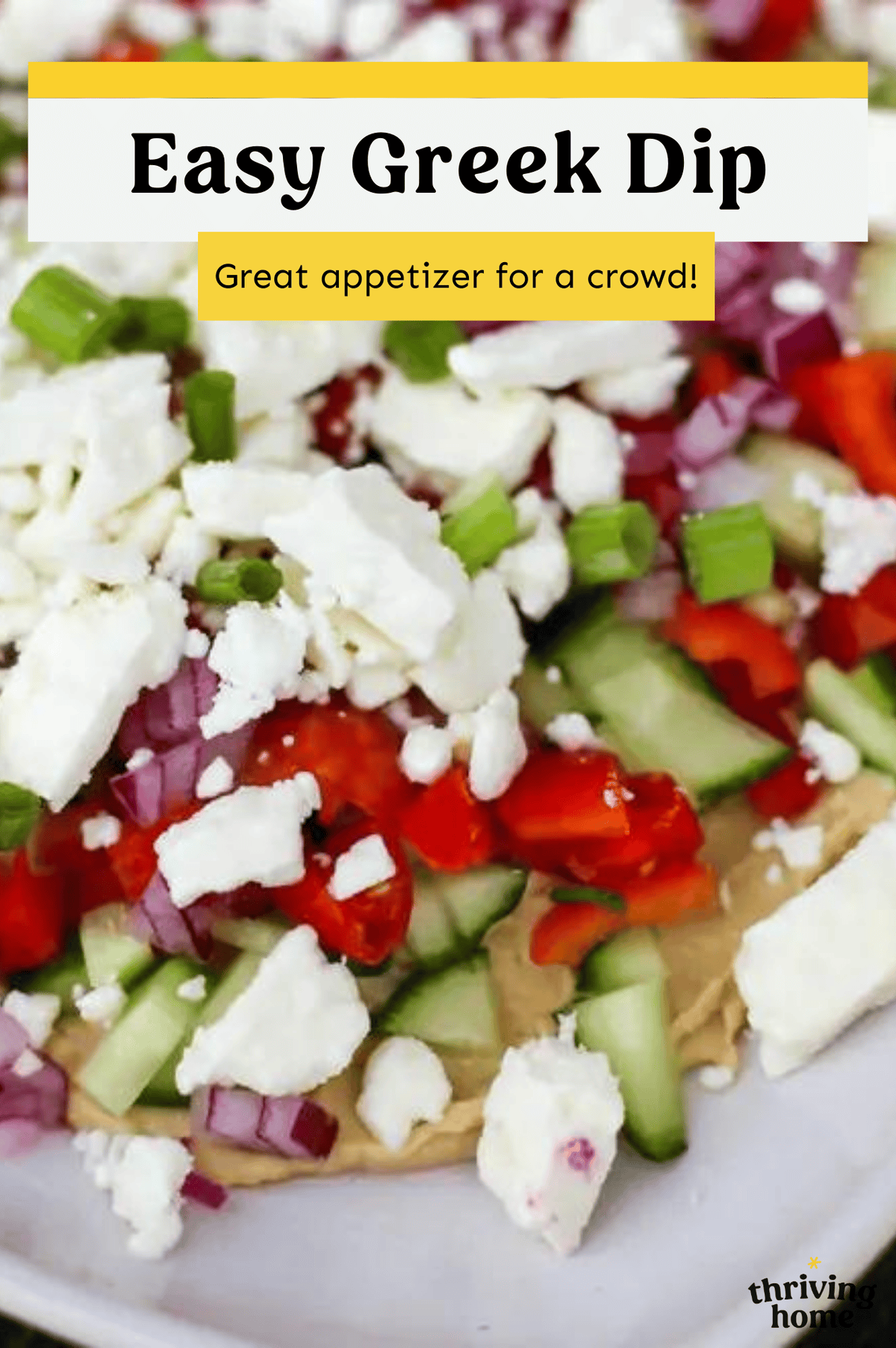 Layered Greek dip with humus, Feta, cucumbers and more.