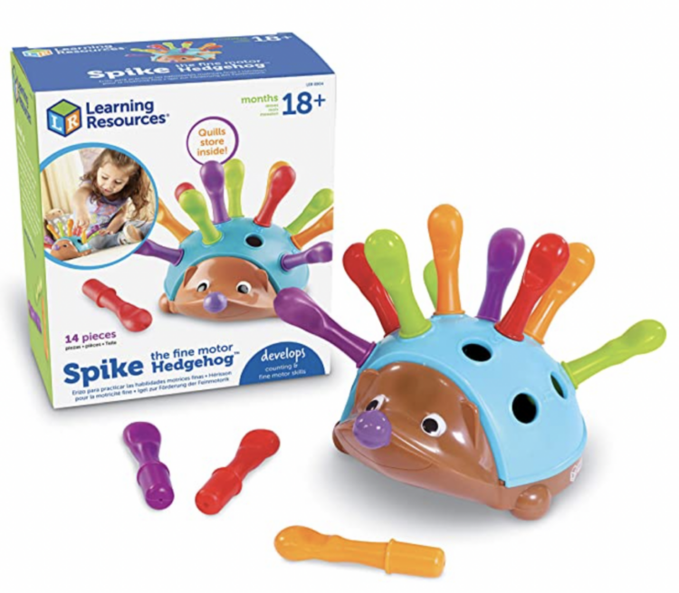 Spike the Fine Motor Hedgehog sitting in front of the box it comes in.