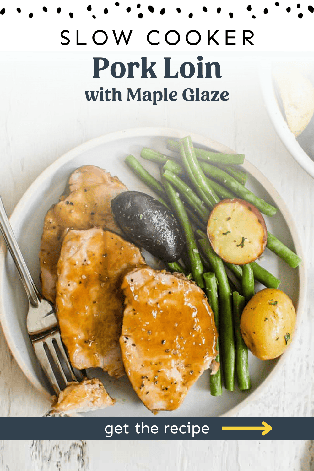 Sliced pork loin on a plate with maple glaze, green beans, and baby potatoes.