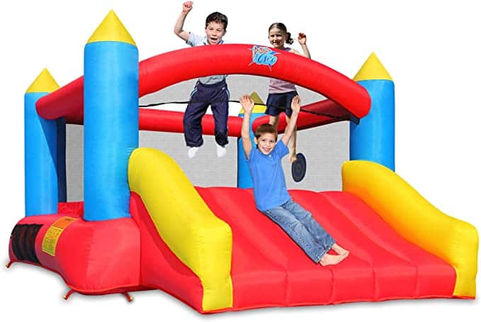 Three kids playing on a bounce house that can fit in many basement play rooms.