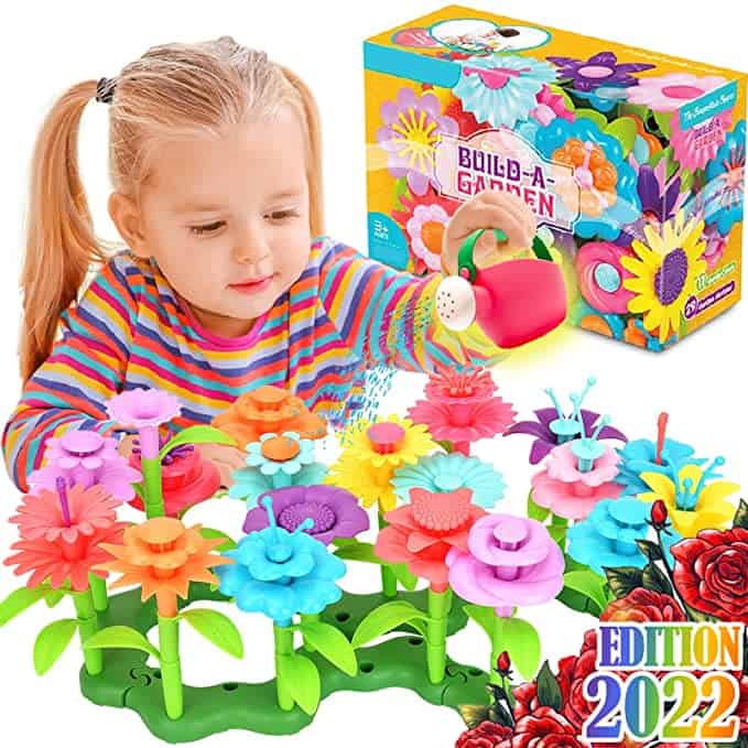 Child playing with the Build A Garden toy - different color hard plastic flowers that can be rearranged.