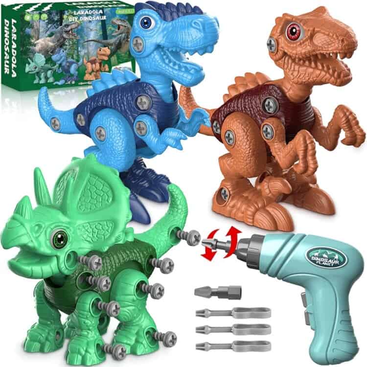 Three different take a part dinosaur toys with the toy drill kids use to take them apart sitting next to them.