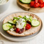 A Greek pork pita with cucumber, tomato, and tzatziki sauce.