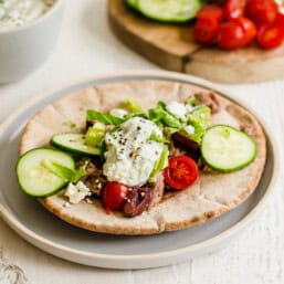 A Greek pork pita with cucumber, tomato, and tzatziki sauce.