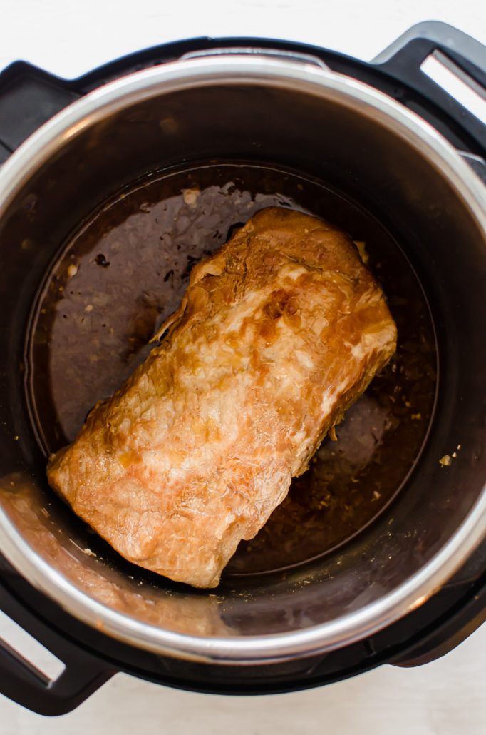 A cooked pork loin in an instant pot