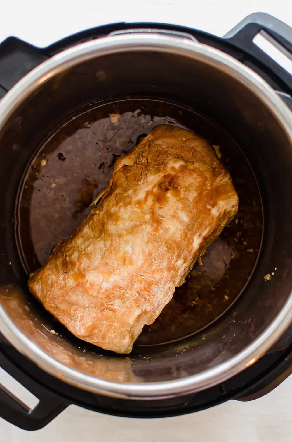 A cooked pork loin in an Instant Pot.