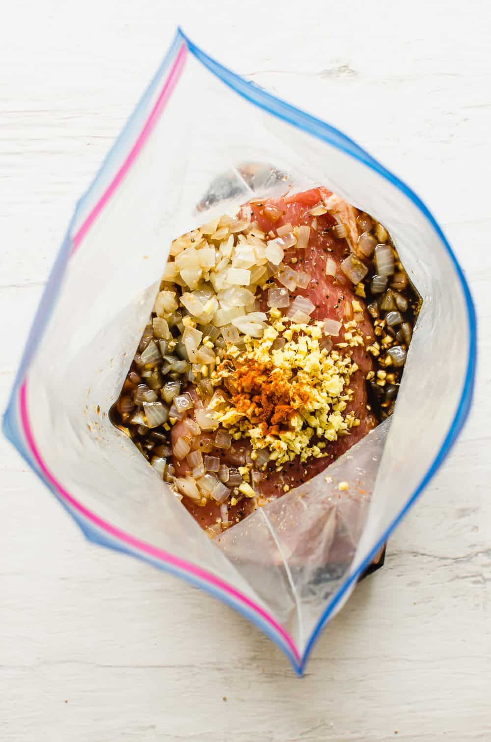 Pork loin in a marinade in a freezer bag.